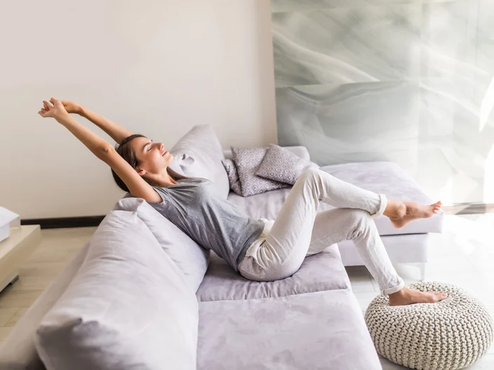 smiling-young-woman-relax-lying-couch