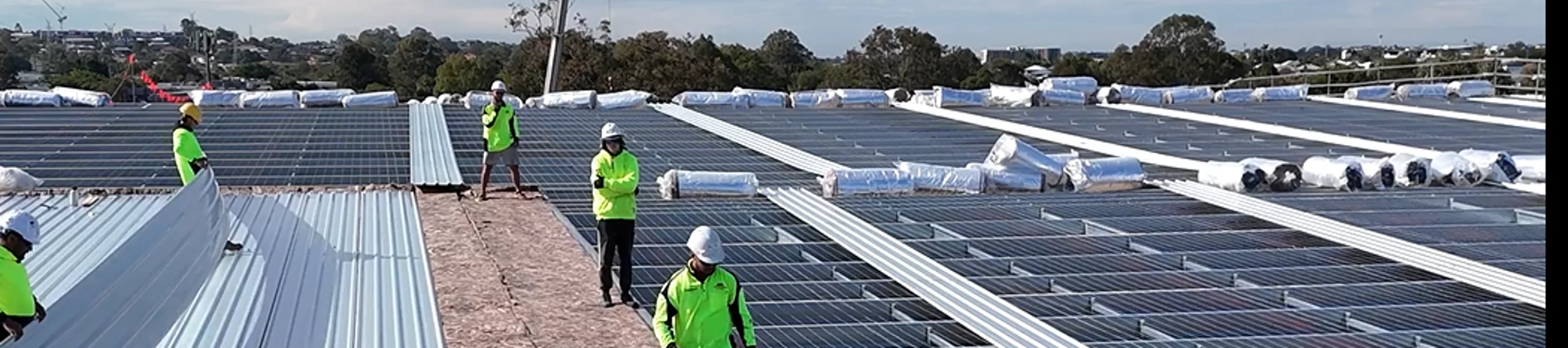 Metal roof insulation roll installation