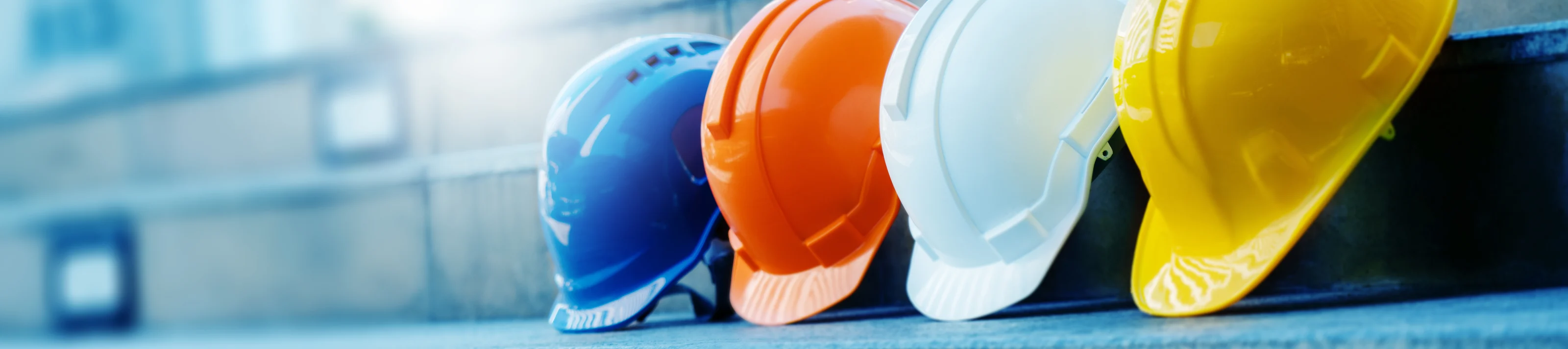 Multicolored Safety Construction Worker Hats. Teamwork of the co