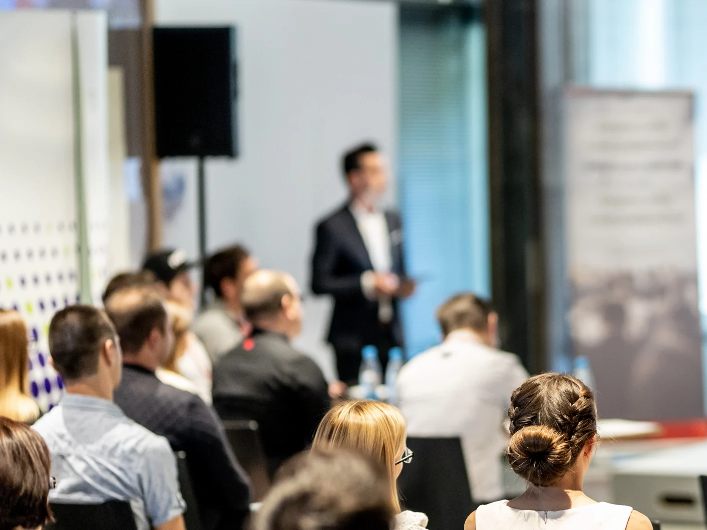 Male business speaker giving a talk at business conference event