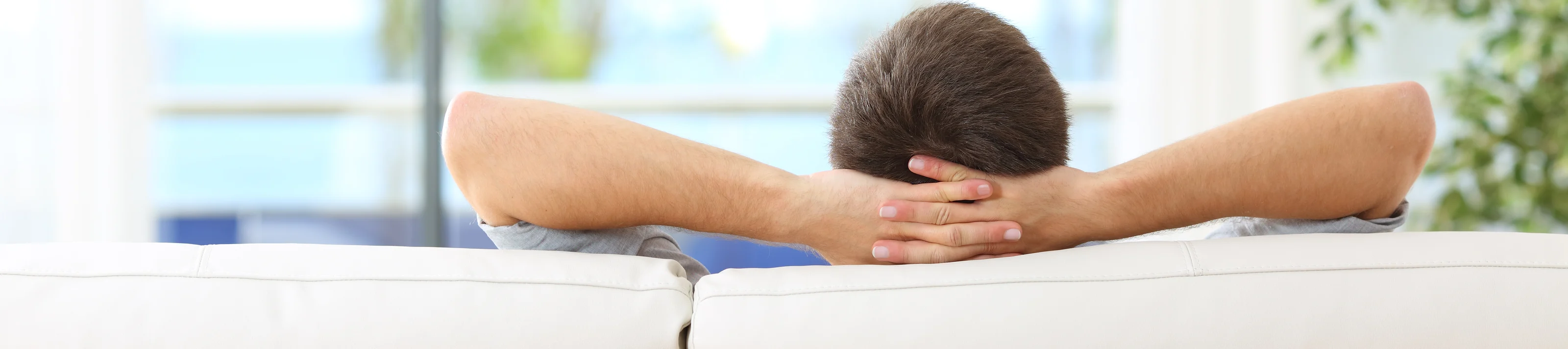 Man relaxed on a couch at home