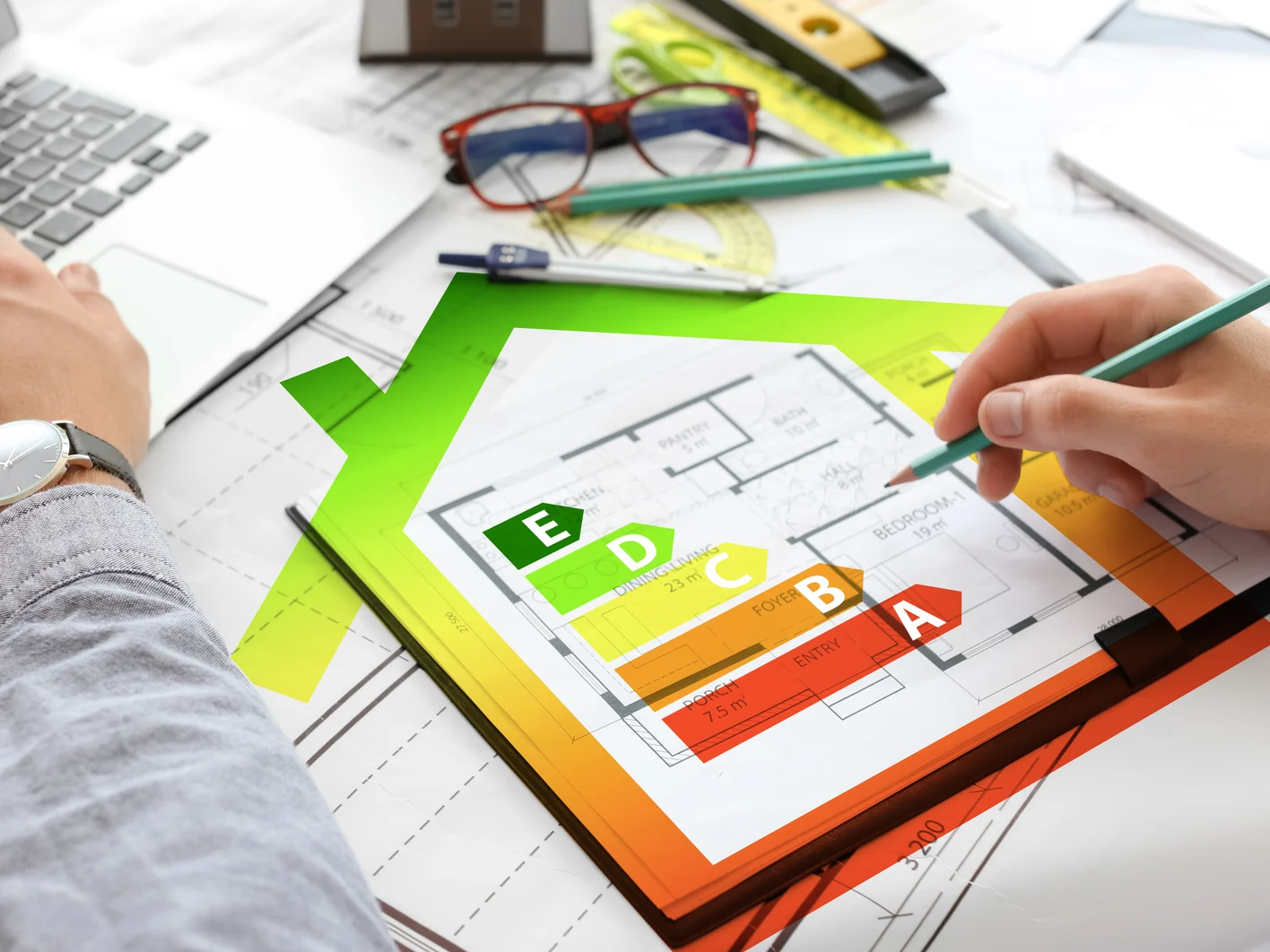 Architect working on project of building in office, closeup. Concept of energy efficiency