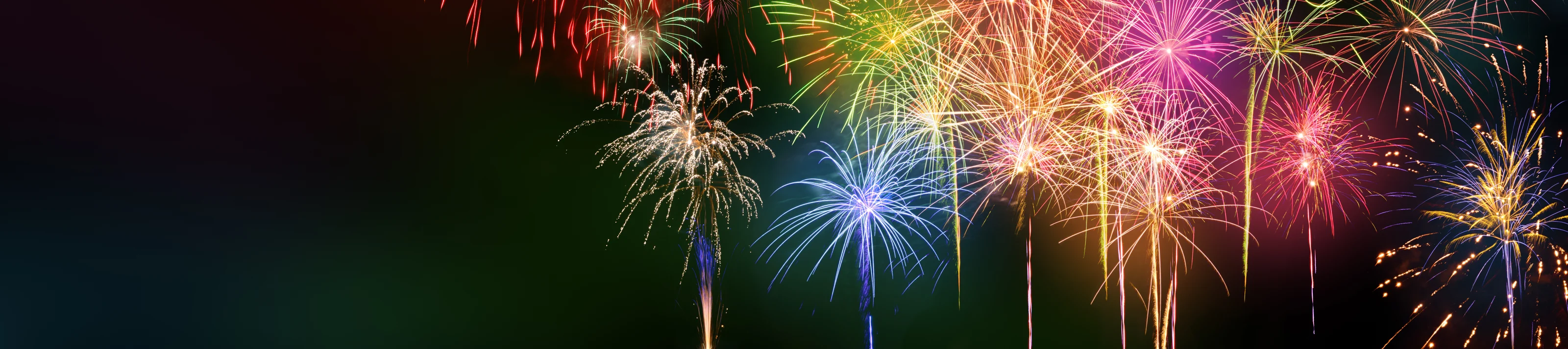 Colorful fireworks with wide dark copy space