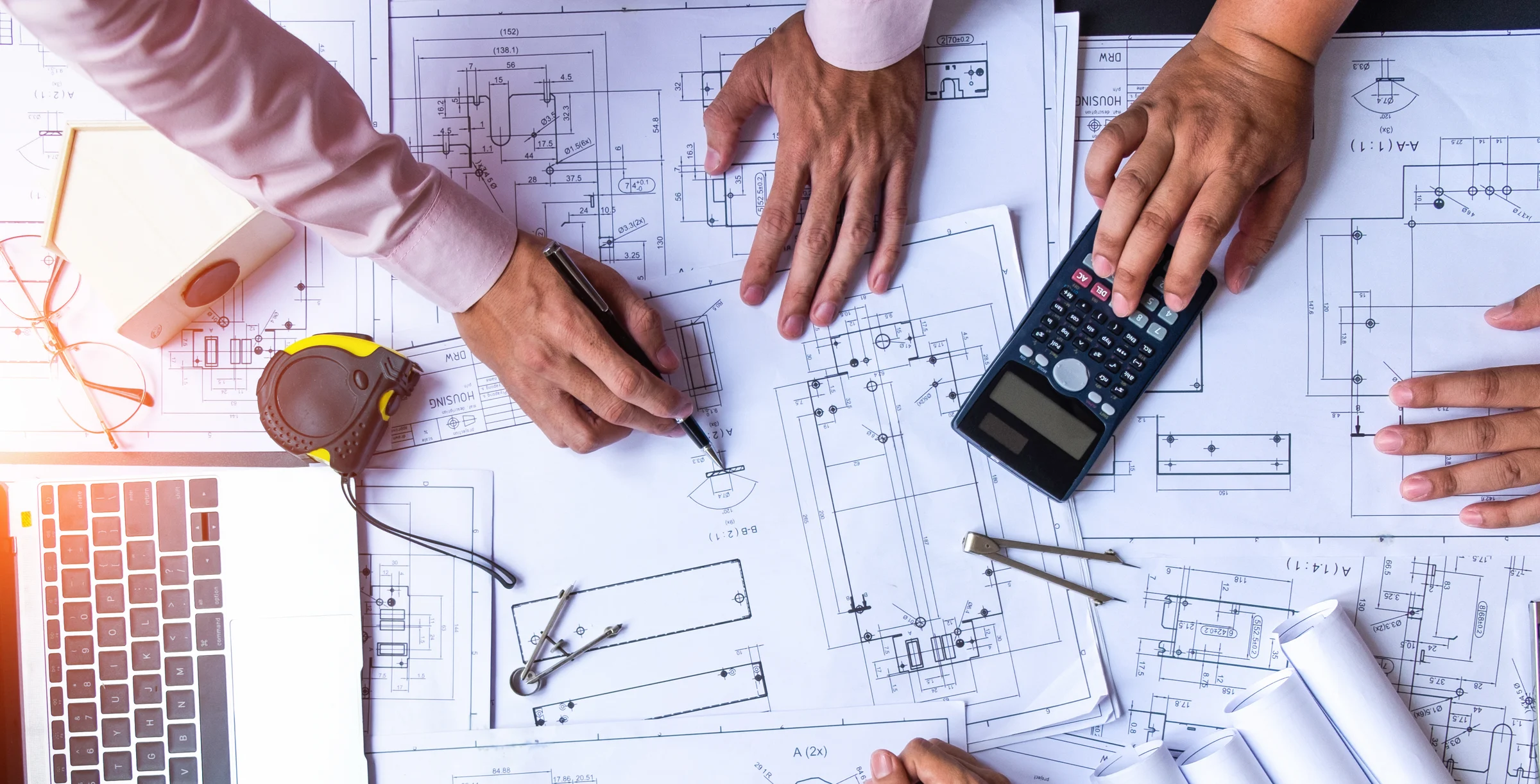 engineers pointing to building on blueprint and using laptop to drawing design building Pr