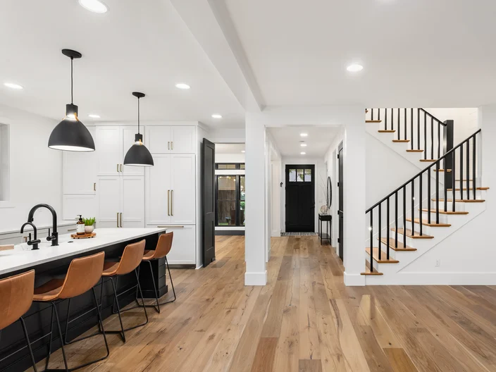 Kitchen and living room interior in new luxury home with open concept floor plan Features 