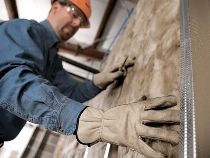Worker Installing Acoustic Wall Insulation