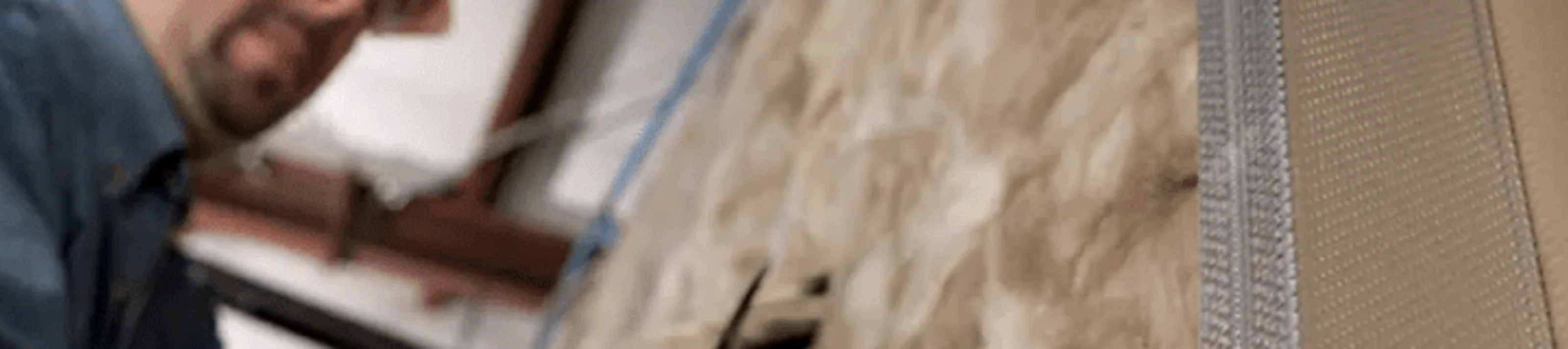 Worker Installing Acoustic Wall Insulation