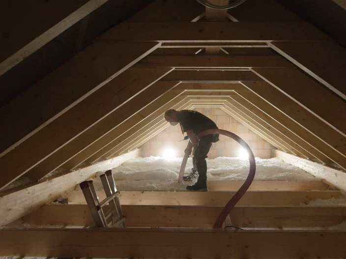 Installer blowing wool Supafil attic