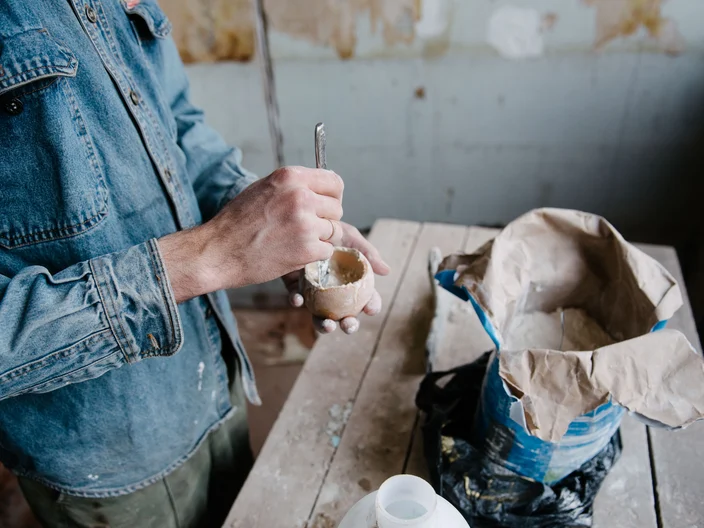 Manually mixing gypsum and water