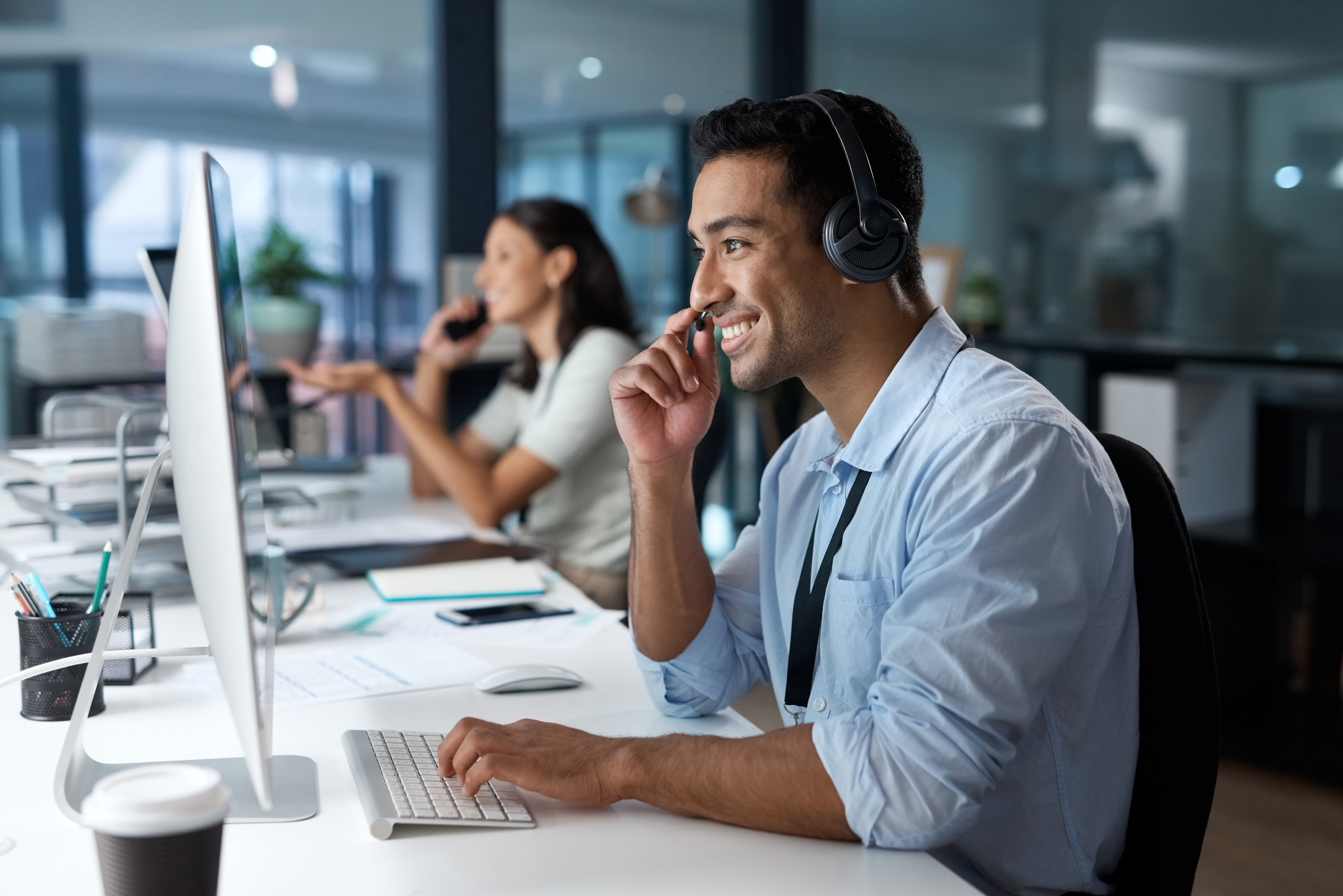 Dedicated service creates dedicated customers Shot of a young man using a headset and com