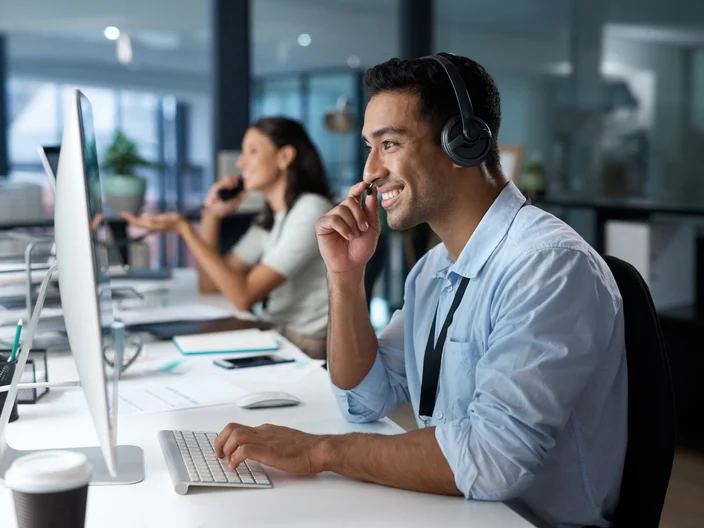 Dedicated service creates dedicated customers Shot of a young man using a headset and com