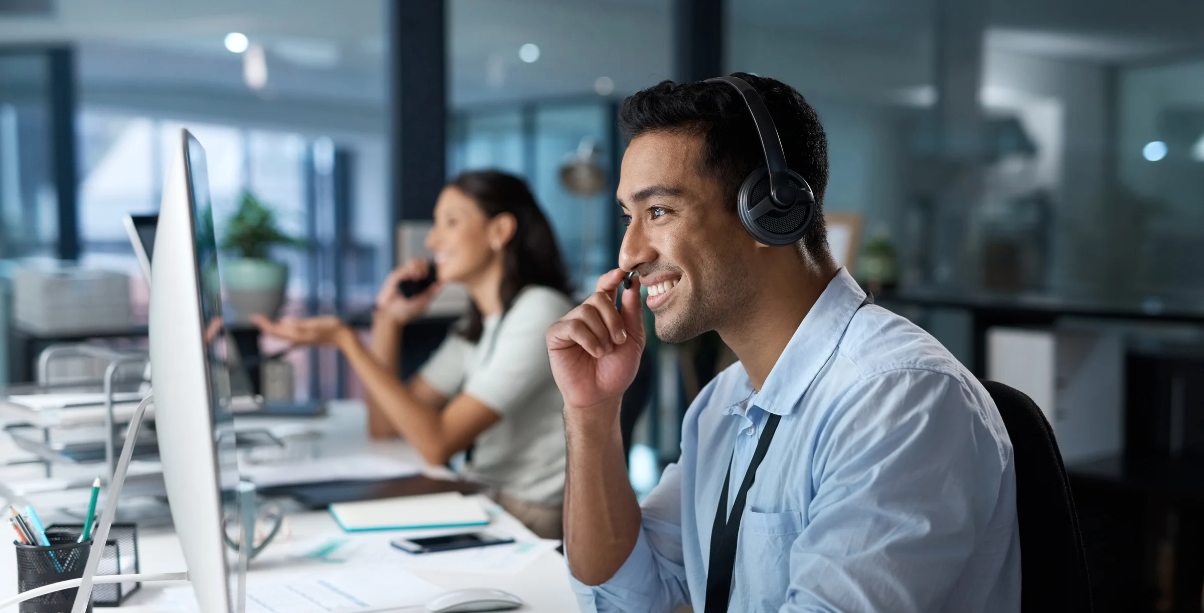 Dedicated service creates dedicated customers Shot of a young man using a headset and com