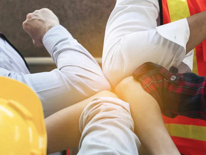 Team of Engineers wear reflective vest and safety helmet giving elbow greeting to avoid the spread of coronavirus (COVID-19). Greeting with bump elbows instead. Teamwork and social distance concept.