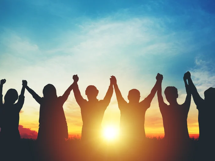 Silhouette of group business team making high hands over head in