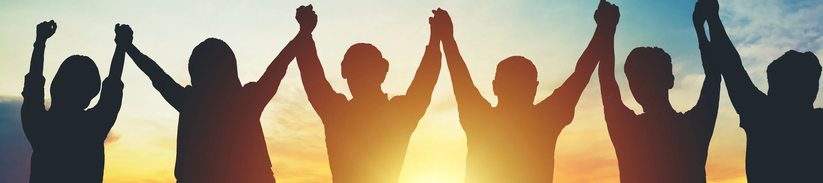 Silhouette of group business team making high hands over head in