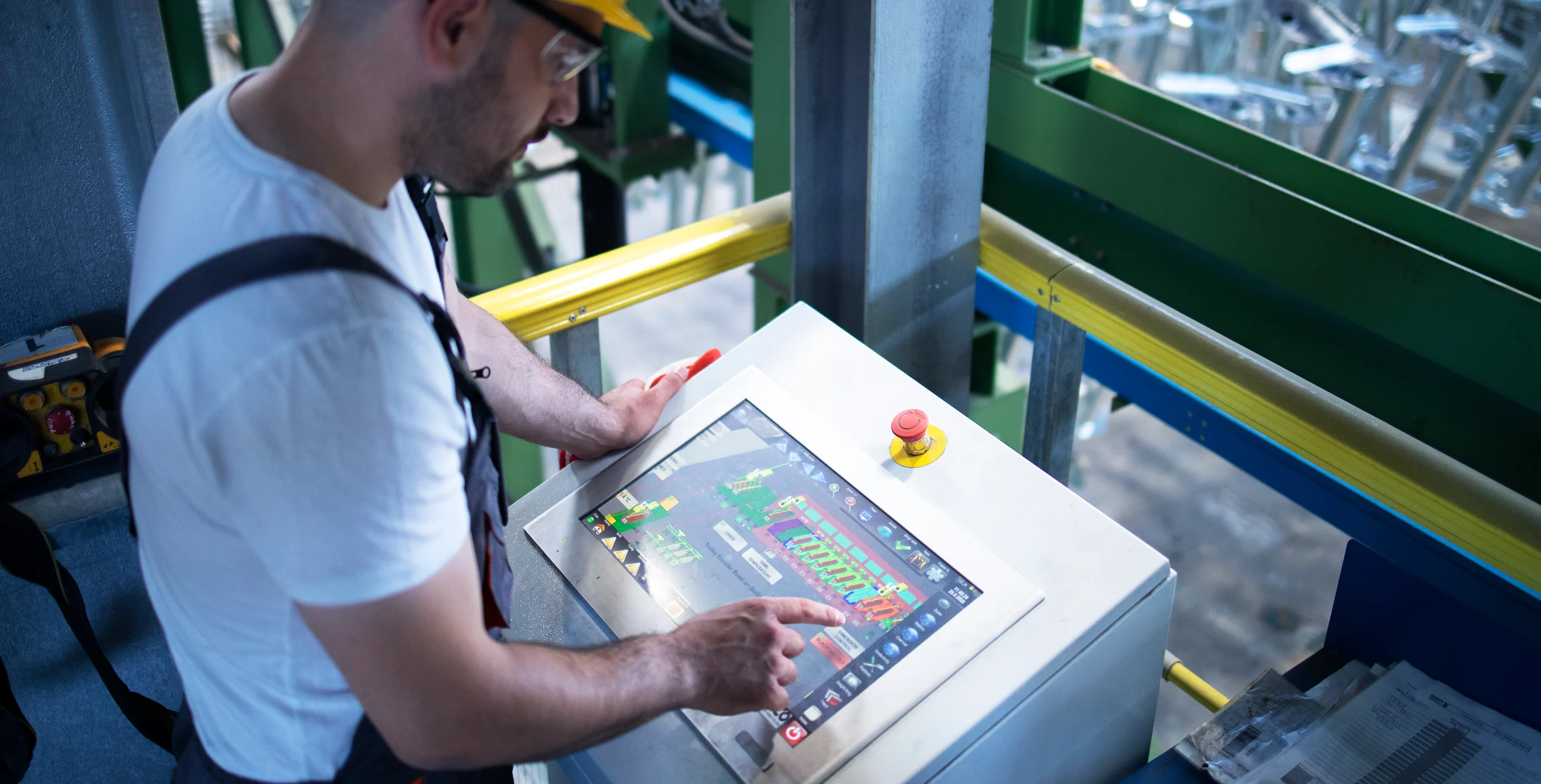 Factory Worker Operating Tablet on Machine