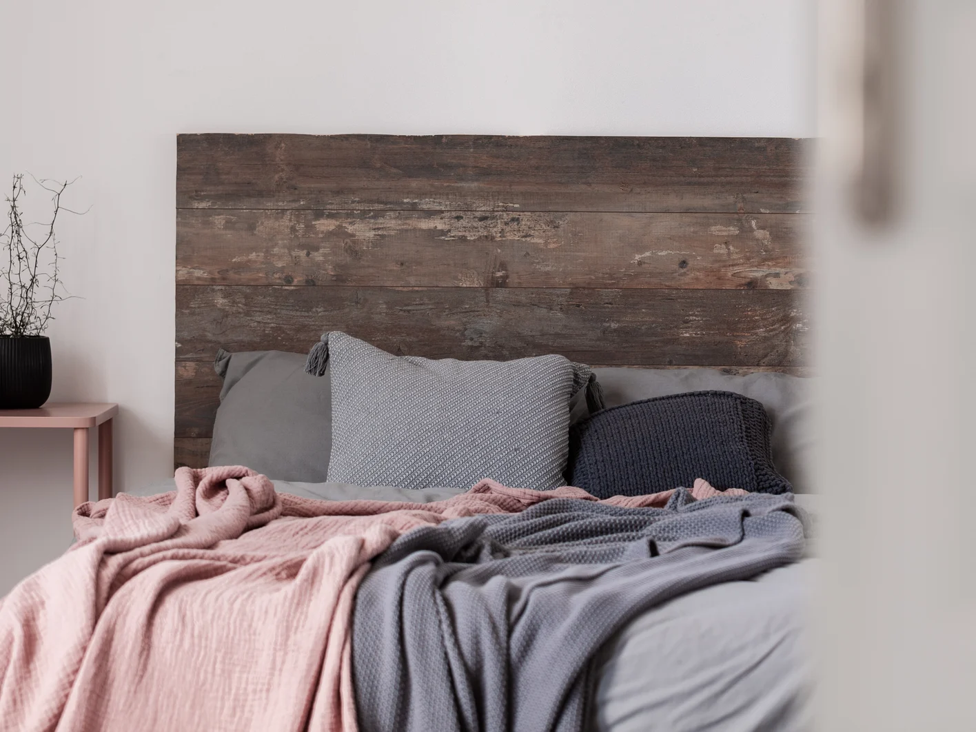 Copy space on empty white wall of rustic bedroom interior