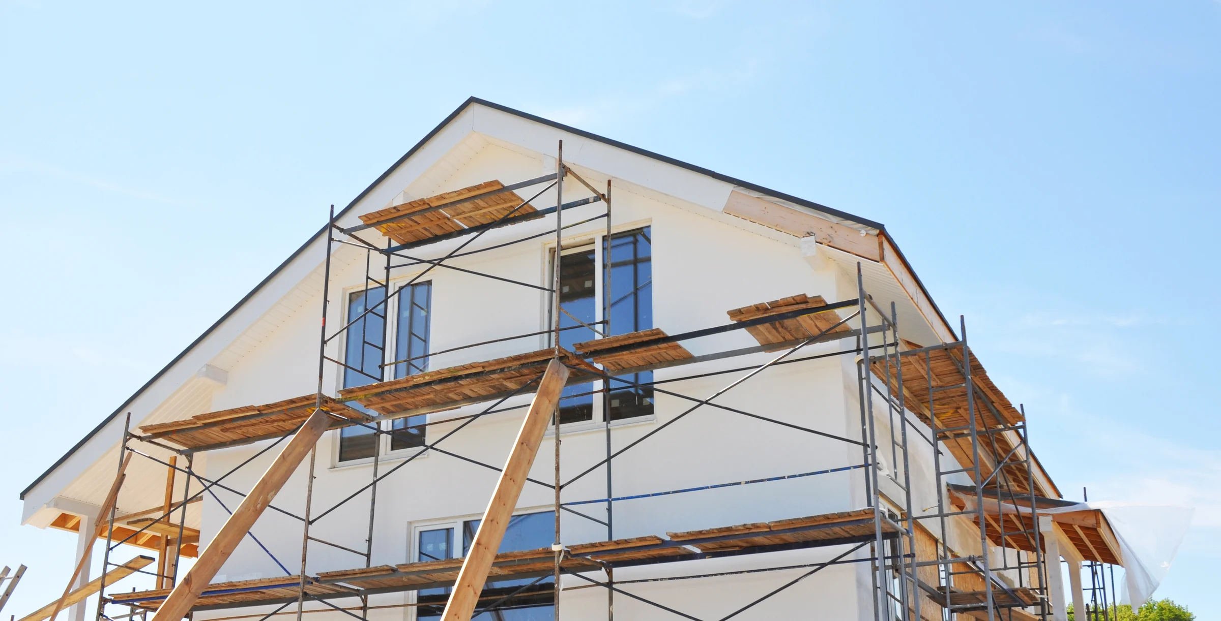 Painting, insulatin and plastering facade house walls after home renovation and remodel