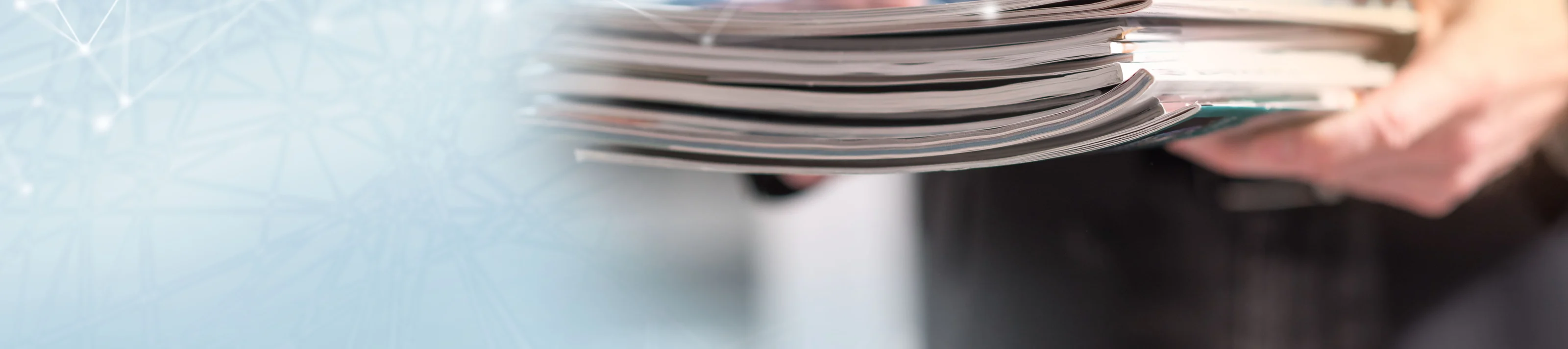 Man holding magazines; panoramic banner