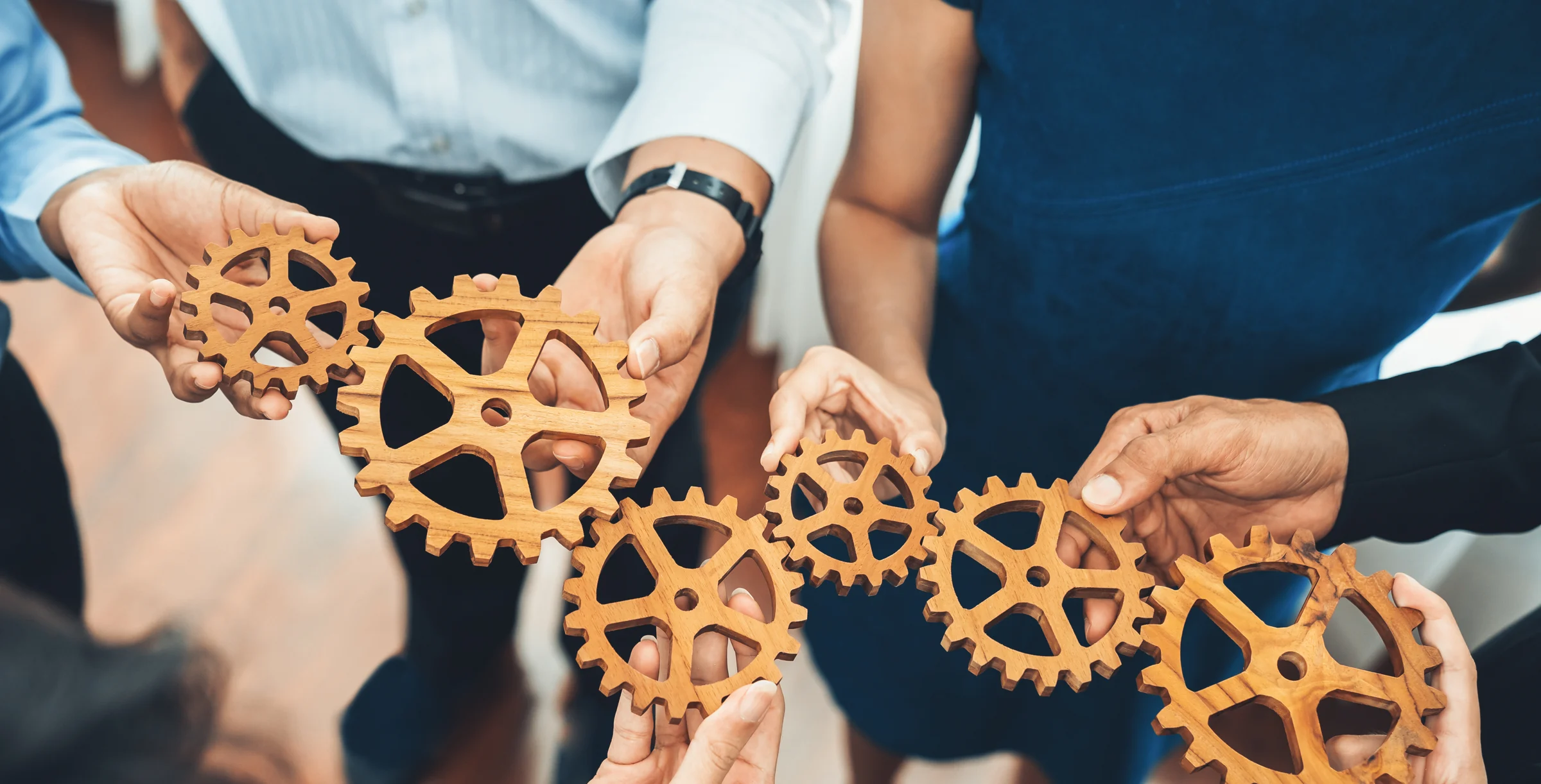 Office worker holding cog wheel as unity and teamwork in workplace. Concord