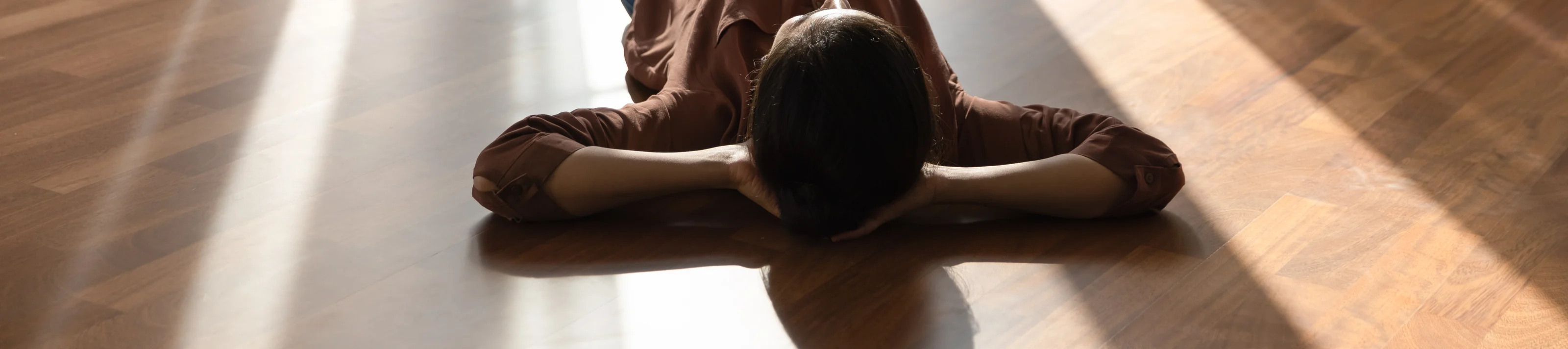 Happy young indian woman lying on warm floor.