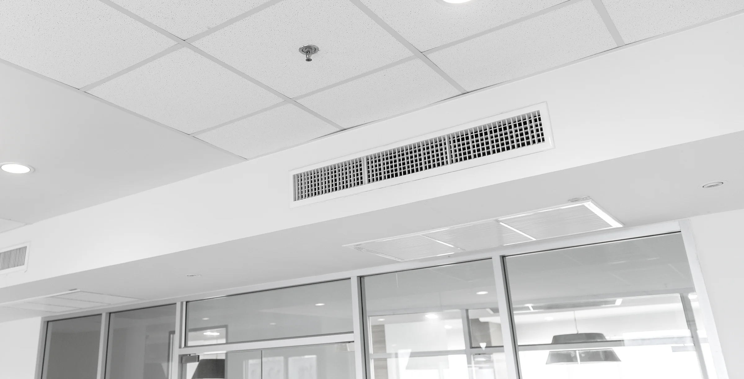 Ceiling mounted cassette type air conditioner and modern lamp light on white ceiling. duct air conditioner for home or office