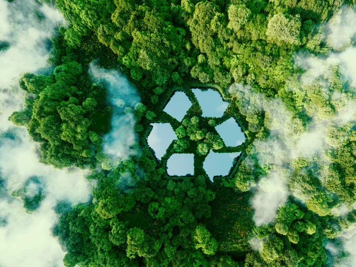 A lake in the shape of a recycling sign in the middle of untouched nature. An ecological metaphor for ecological waste management and a sustainable and economical lifestyle. 3d rendering.
