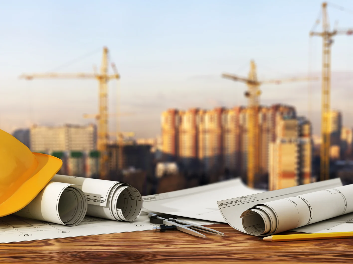 Concept of construction and design. 3d render of blueprints and designer tools on the panorama of construction site.