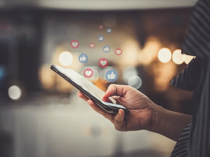 Hand using smartphone with Social media concept.