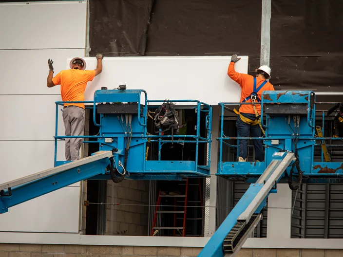 Two construction workers wearing hardhats