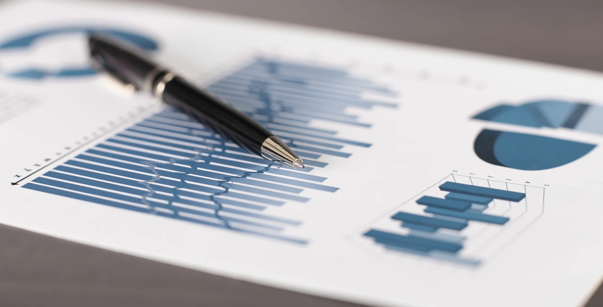 business background.a pen and a sheet with a financial report on