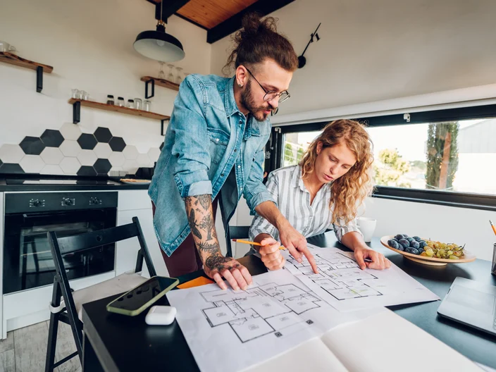 Couple Looking At Blueprint
