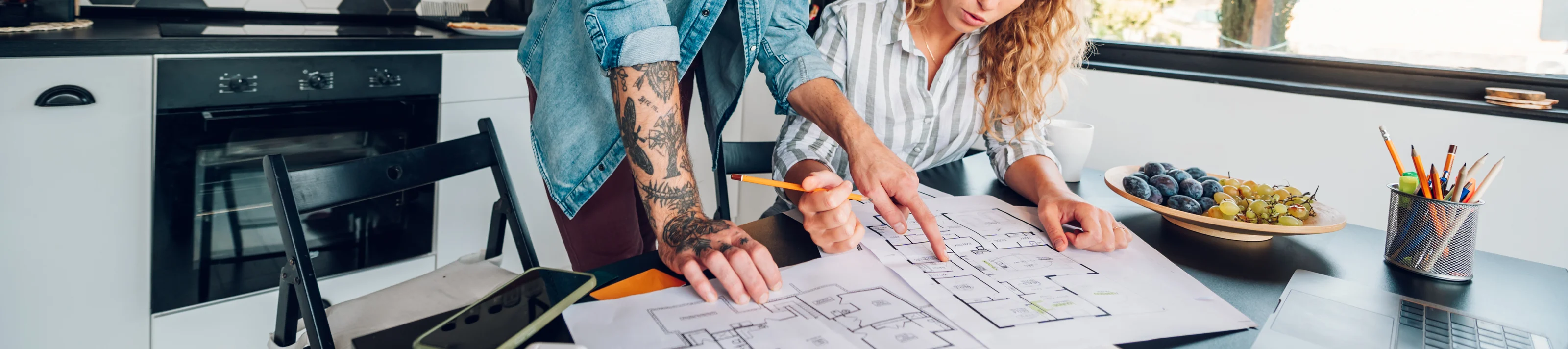 Couple Looking At Blueprint