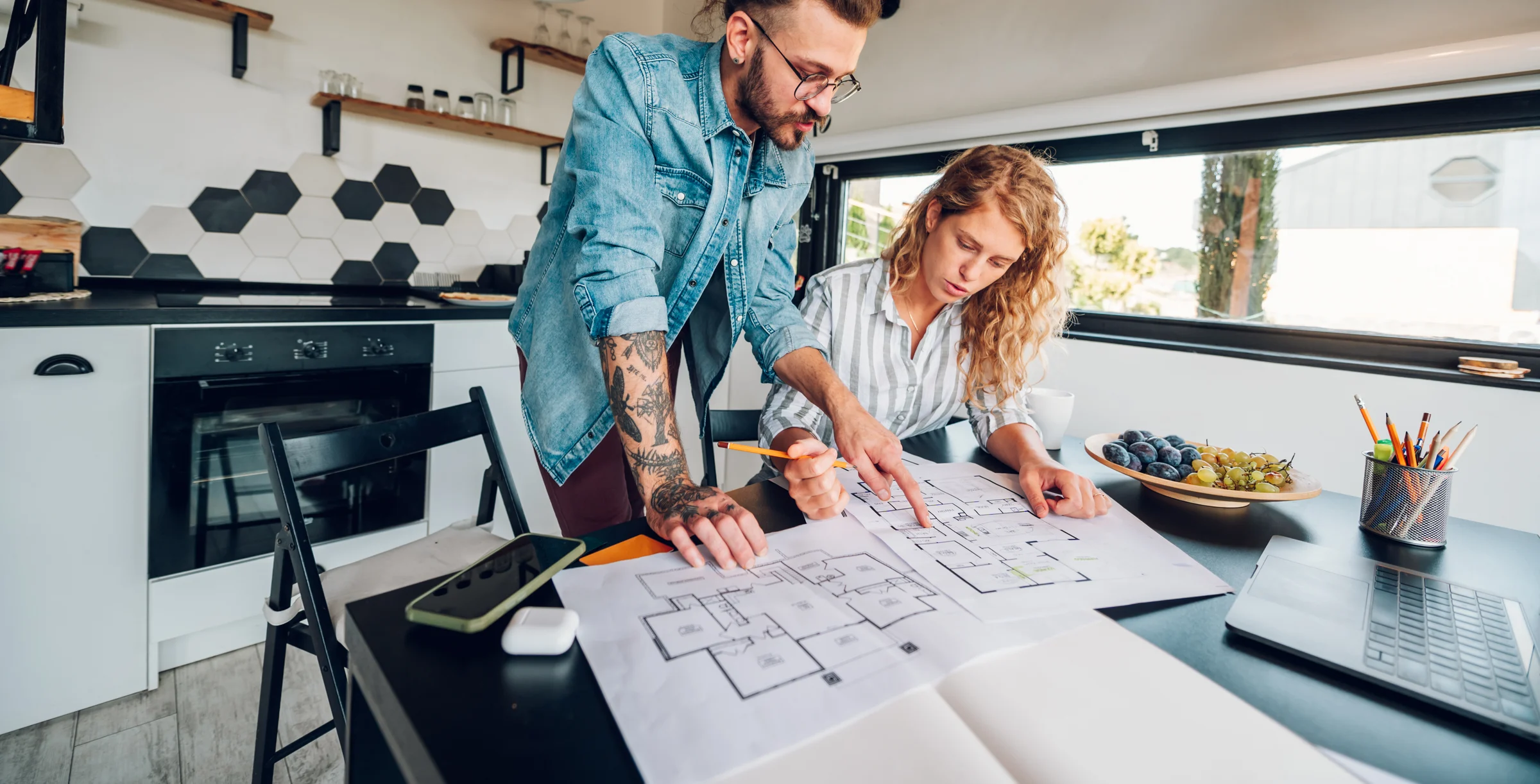 Couple Looking At Blueprint