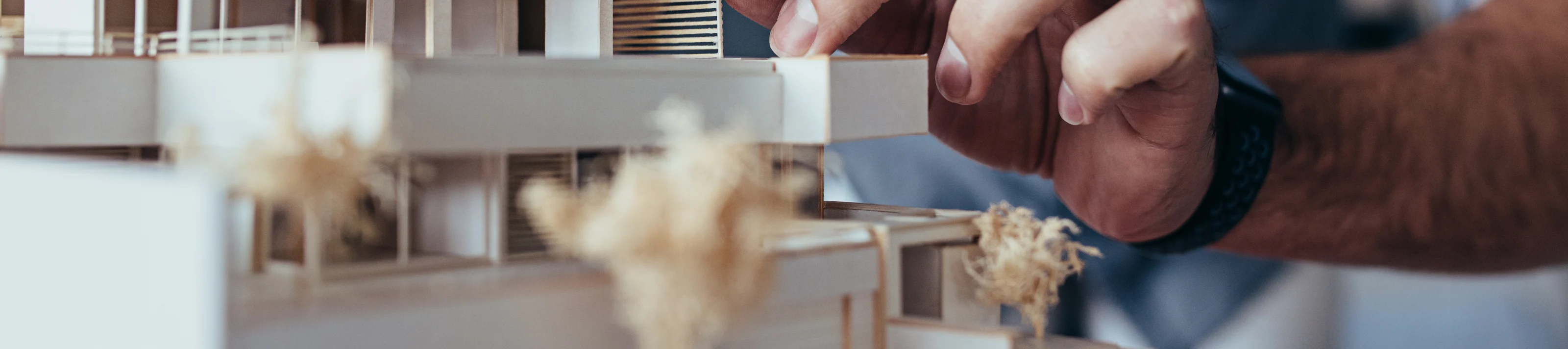 Architect hands making model house