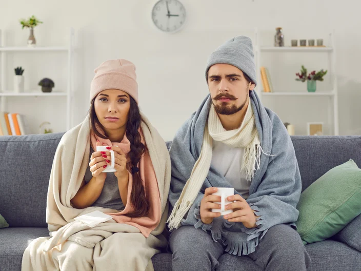 Two people indoors and cold