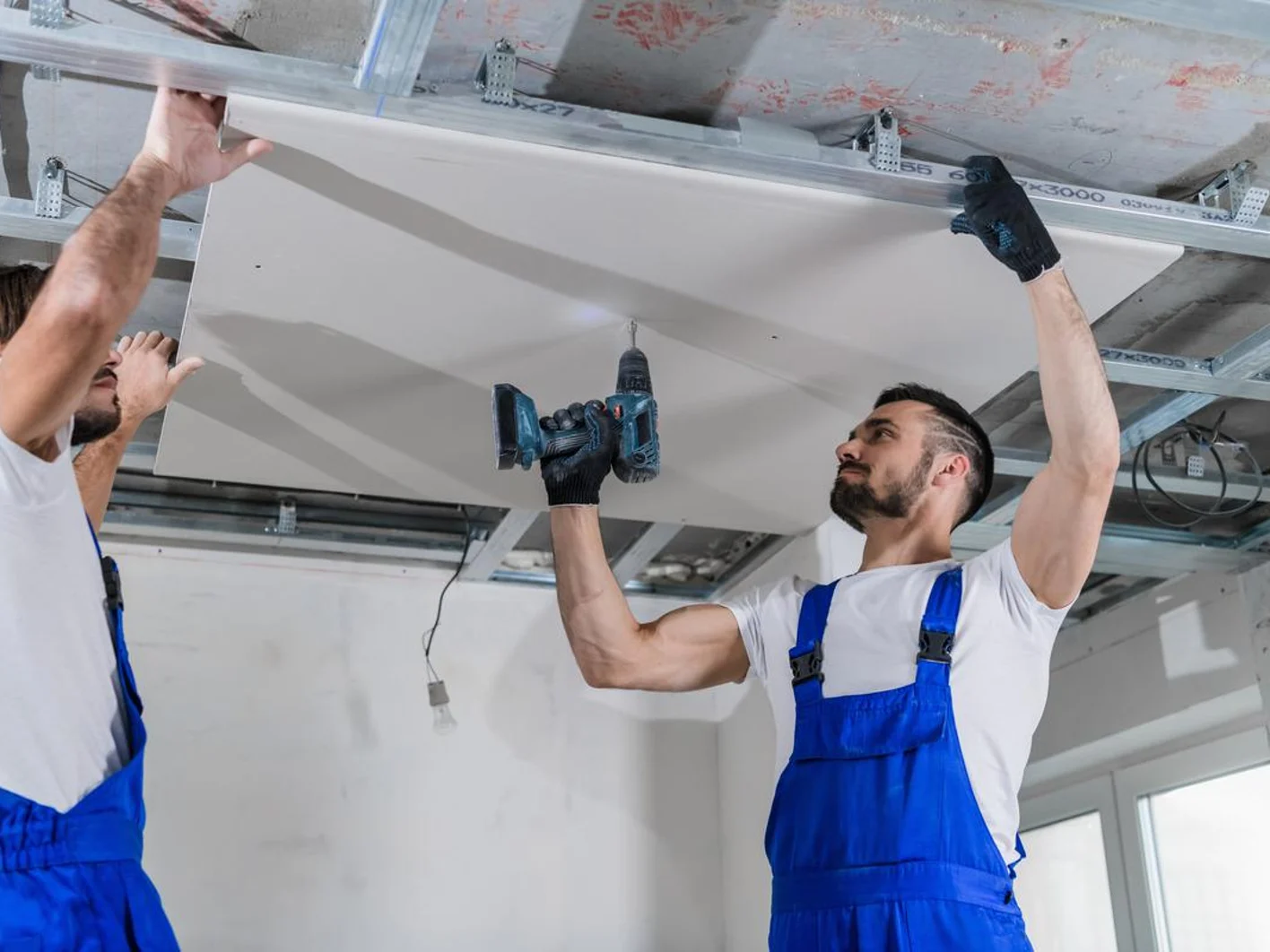 Worker installing drop ceiling