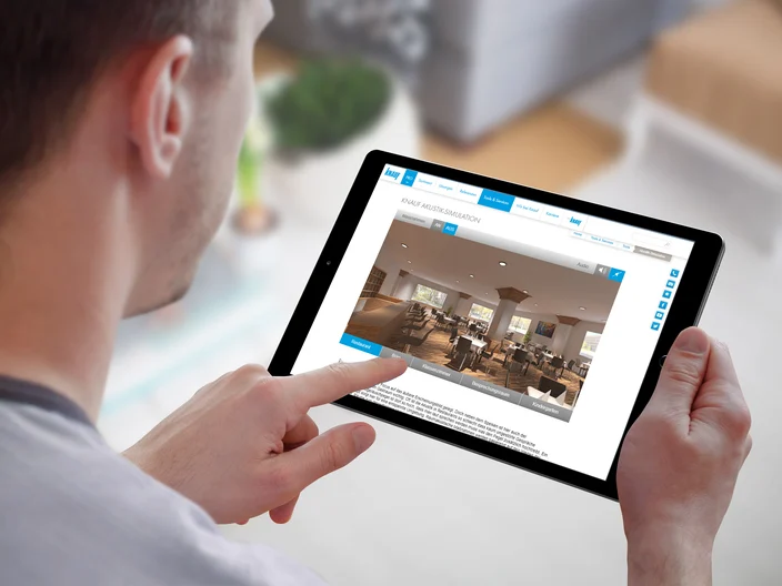 Smart home control on tablet. Interior of living room in the background.