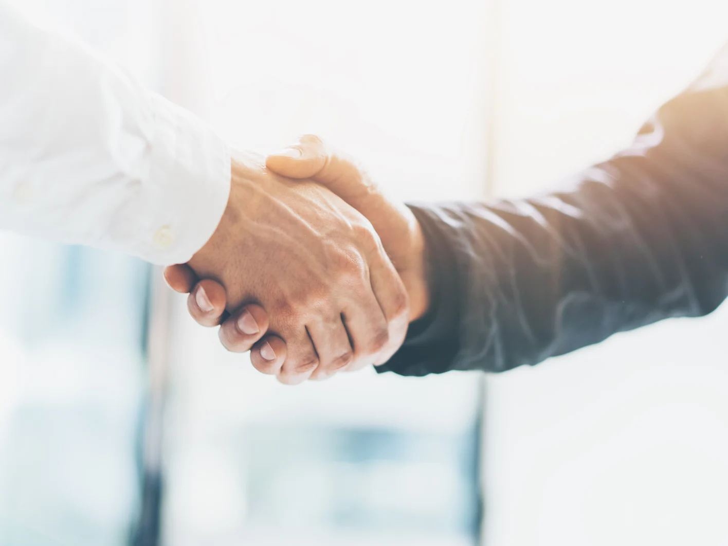 Business partnership meeting. Picture businessmans handshake. Successful businessmen handshaking after good deal. Horizontal, blurred background