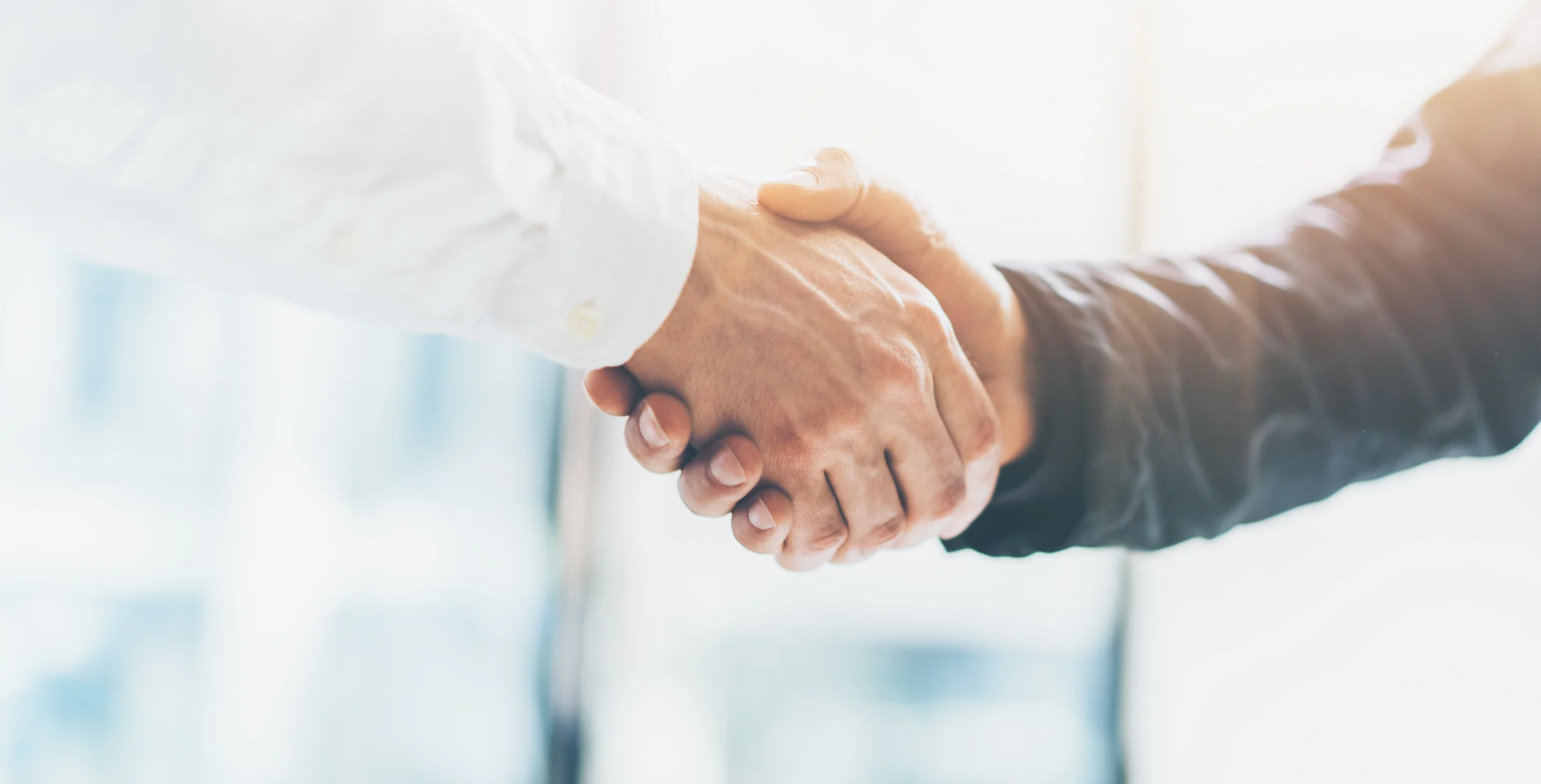 Business partnership meeting. Picture businessmans handshake. Successful businessmen handshaking after good deal. Horizontal, blurred background