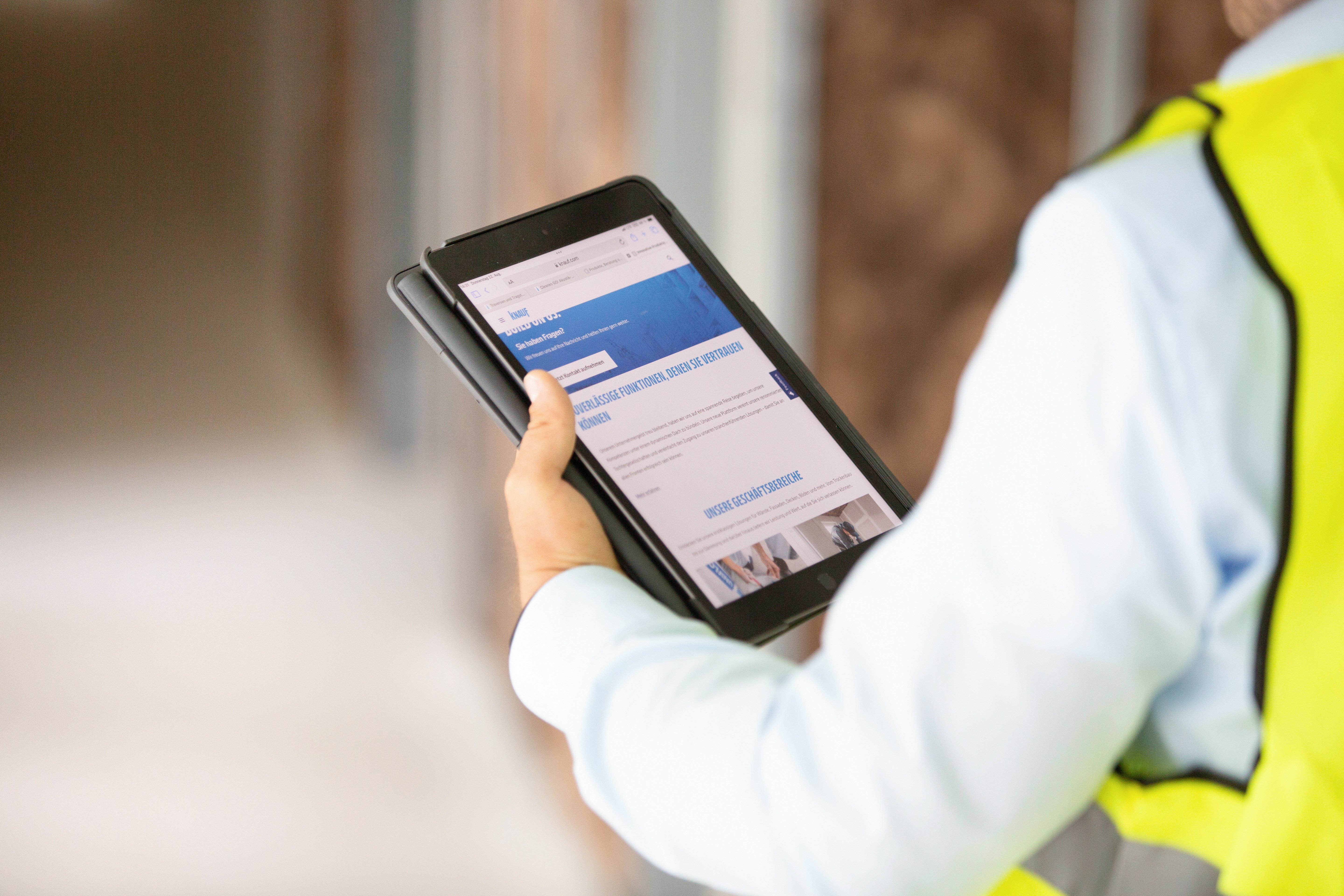 Knauf employee holding tablet knauf website homepage