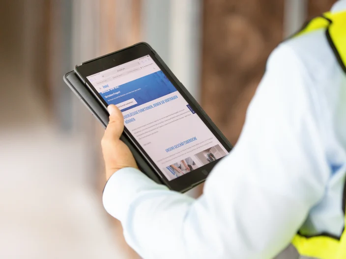 Knauf employee holding tablet knauf website homepage