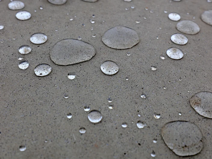 Water droplets on grey ground
