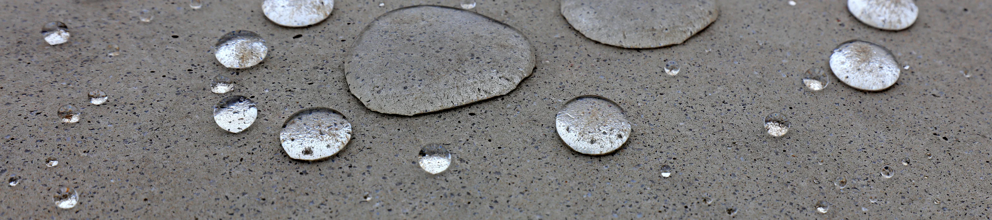 Water droplets on grey ground