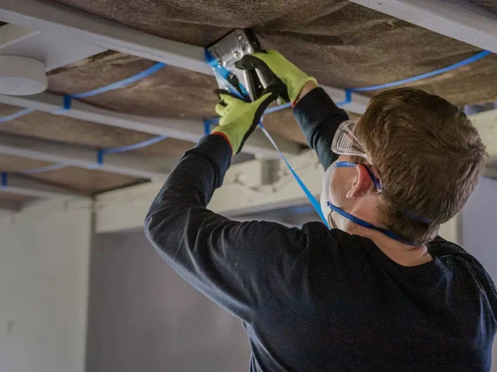 Man installing underfloor insulation
