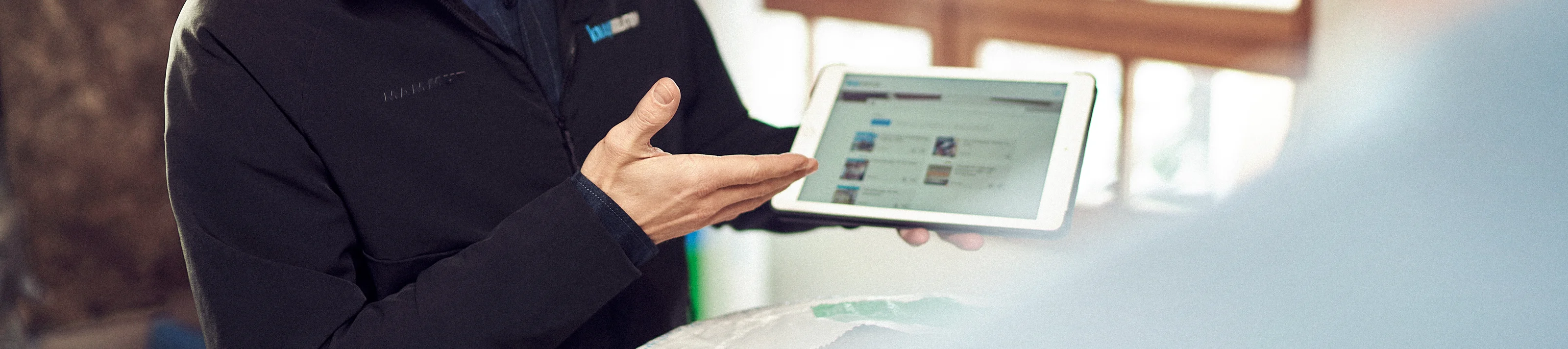 KI man holding ipad tools and services
