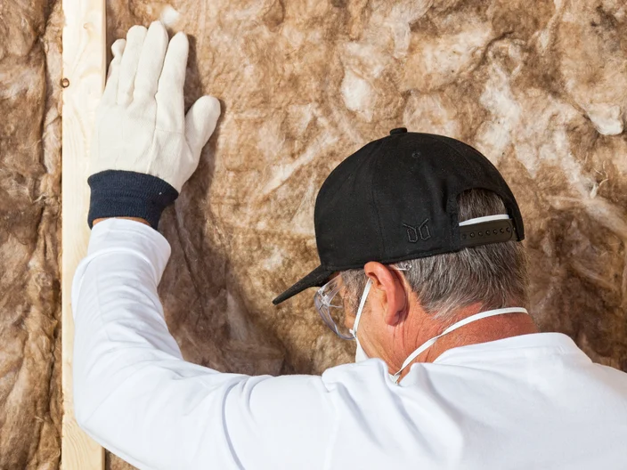 Man installing cavity wall insulation