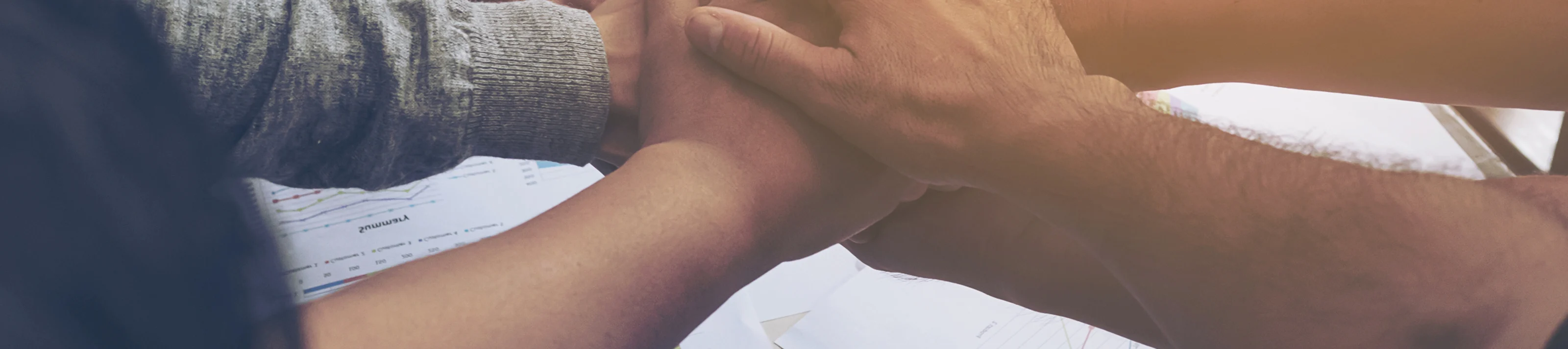 Business people join hand together during their meeting