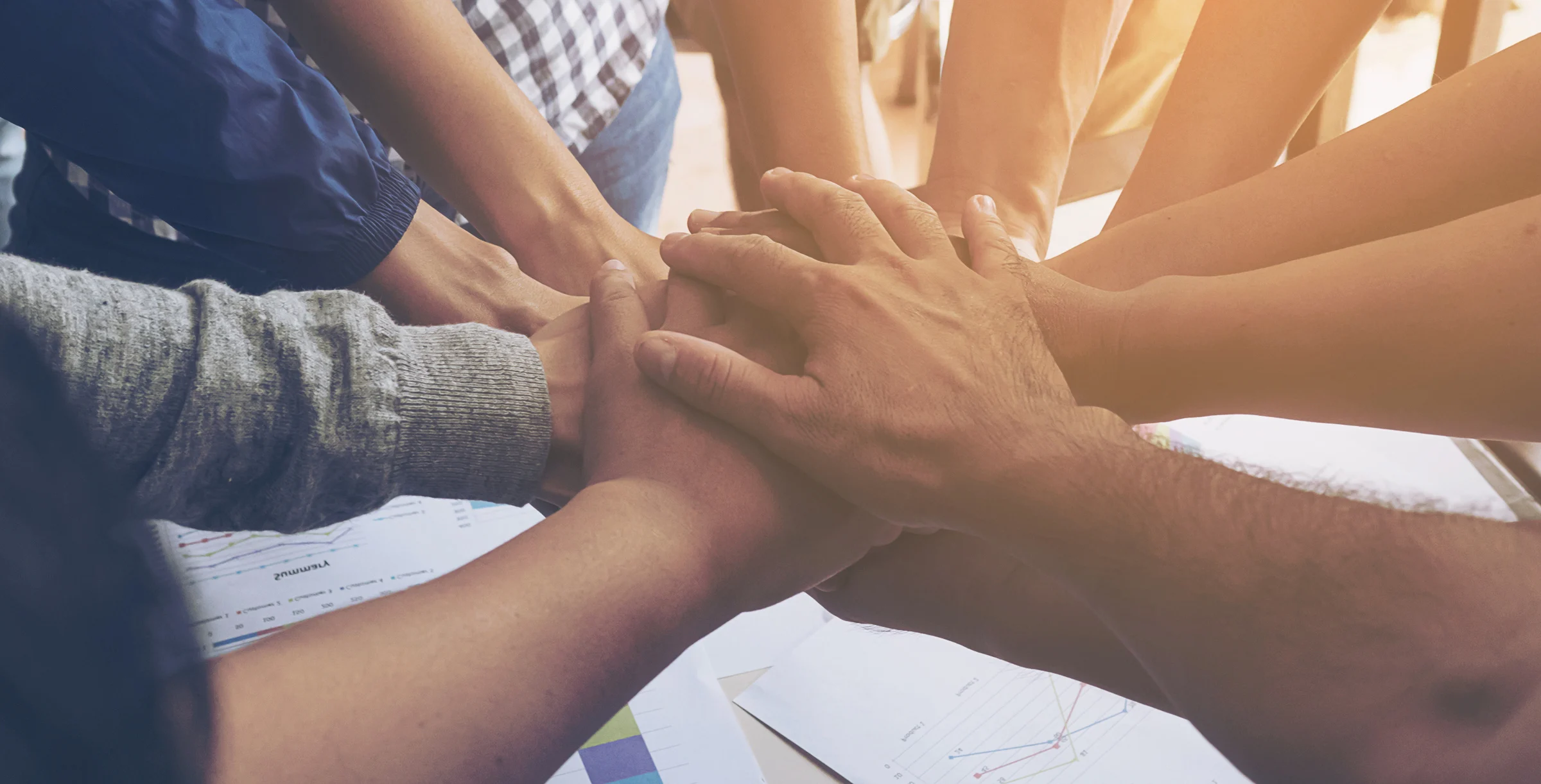 Business people join hand together during their meeting