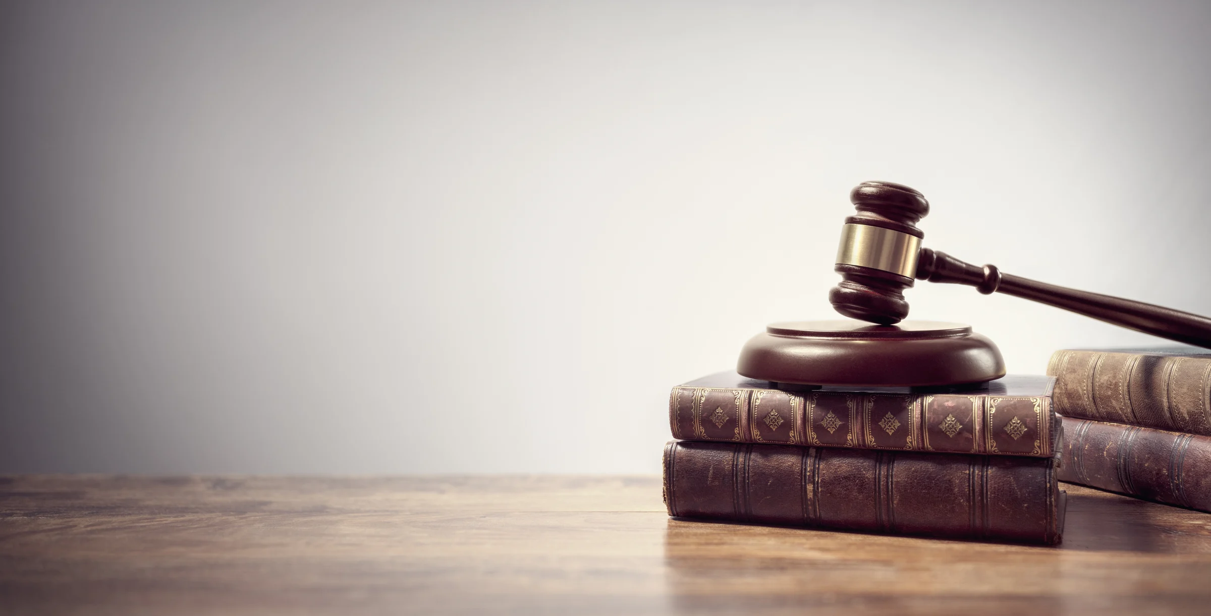 Judge gavel and law books in court background with copy space